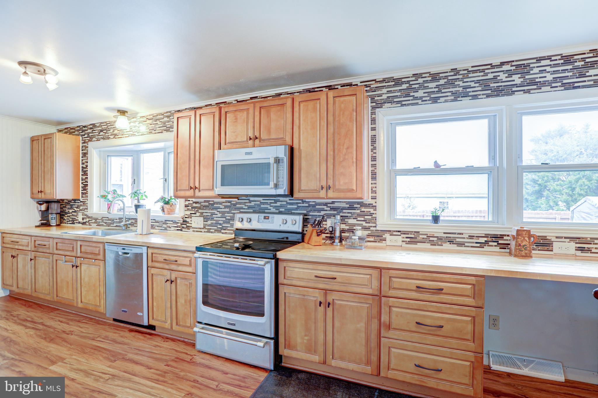 12 Jefferson Road Pennsville, NJ 08070 - Photo 13 of 63 a kitchen with a sink stove and cabinets
