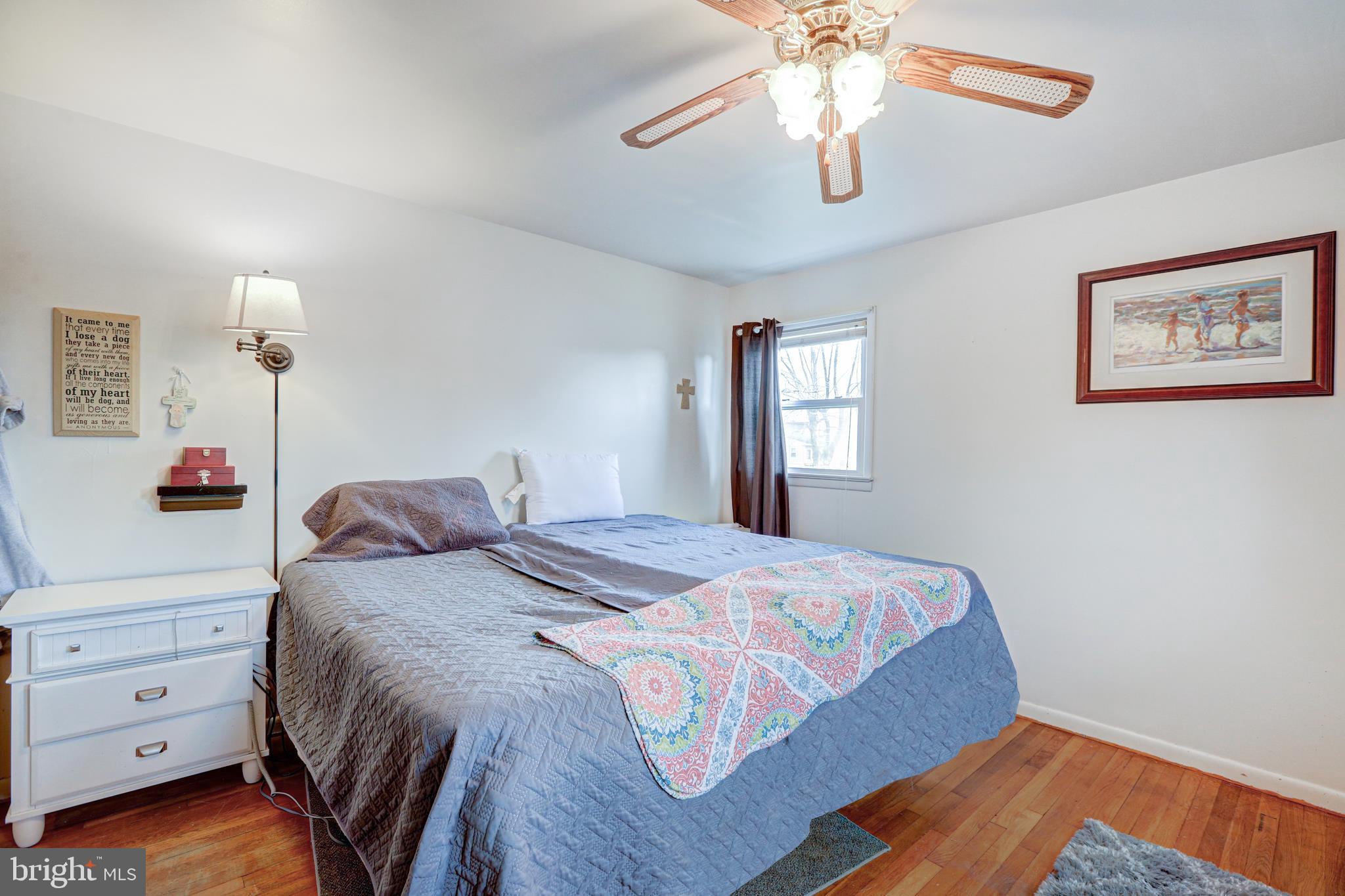 12 Jefferson Road Pennsville, NJ 08070 - Photo 21 of 63 a bedroom with a bed and a chandelier