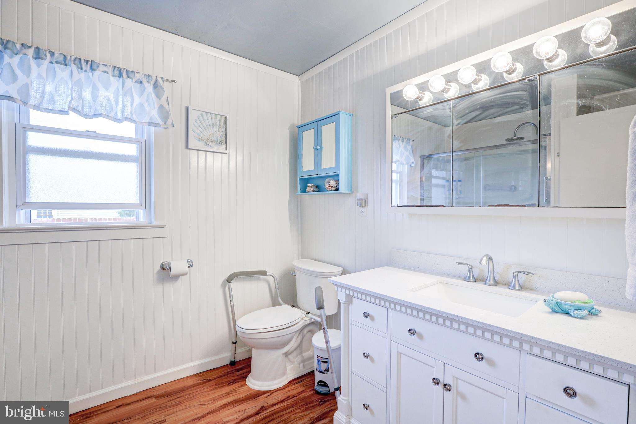 12 Jefferson Road Pennsville, NJ 08070 - Photo 25 of 63 a spacious bathroom with a toilet a sink and mirror