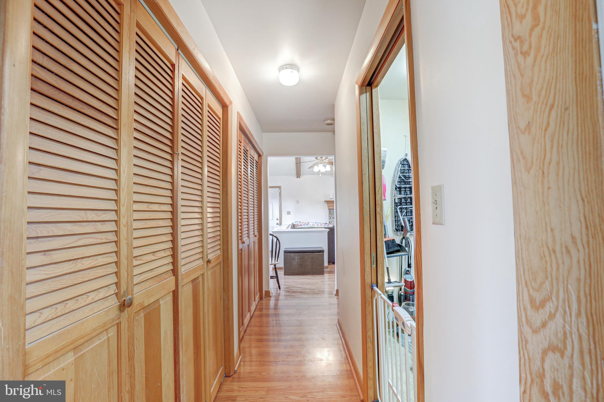 12 Jefferson Road Pennsville, NJ 08070 - Photo 27 of 63 a view of a hallway with wooden floor and a bathroom
