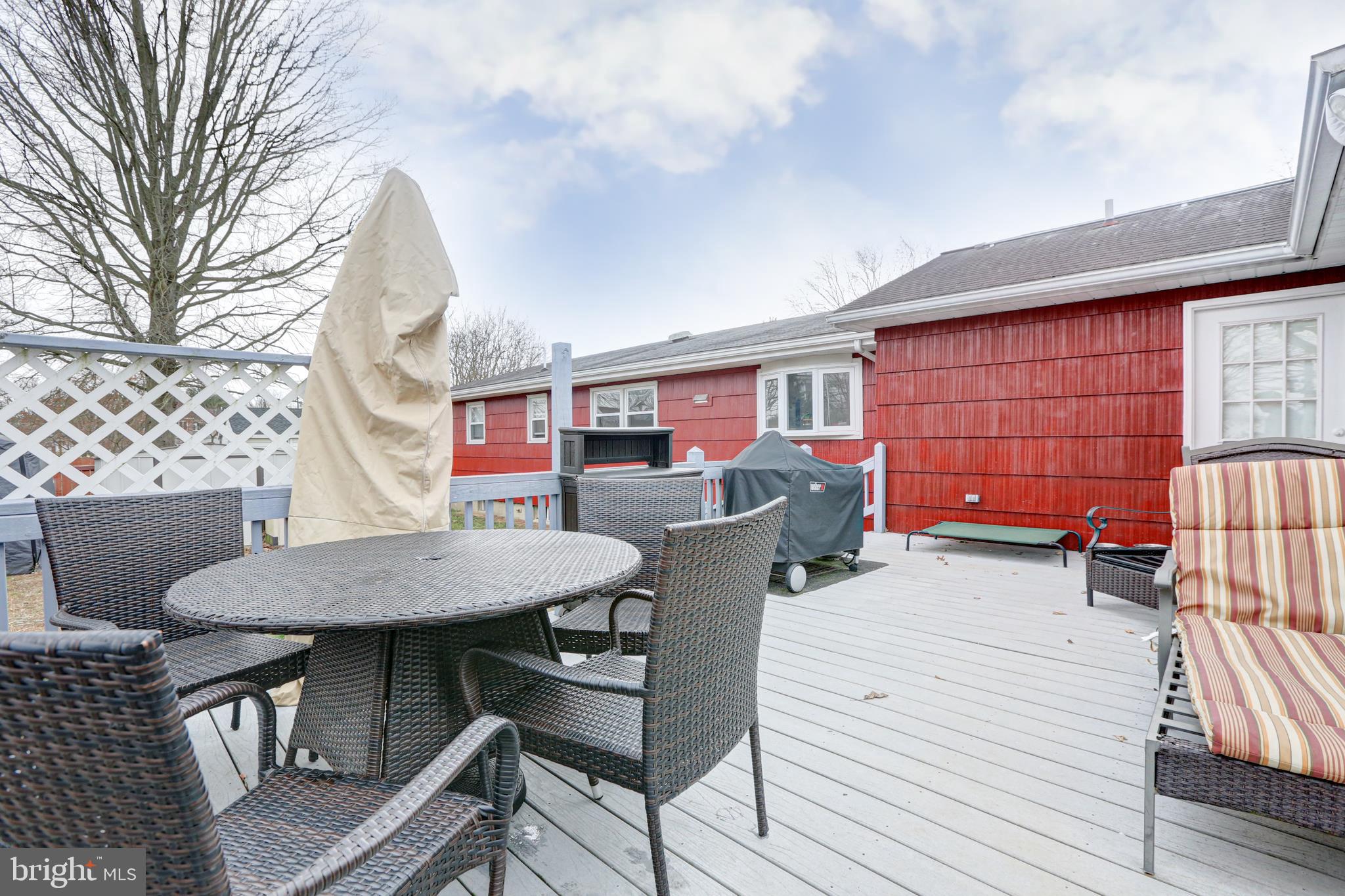 12 Jefferson Road Pennsville, NJ 08070 - Photo 40 of 63 a backyard of a house with barbeque oven table and chairs