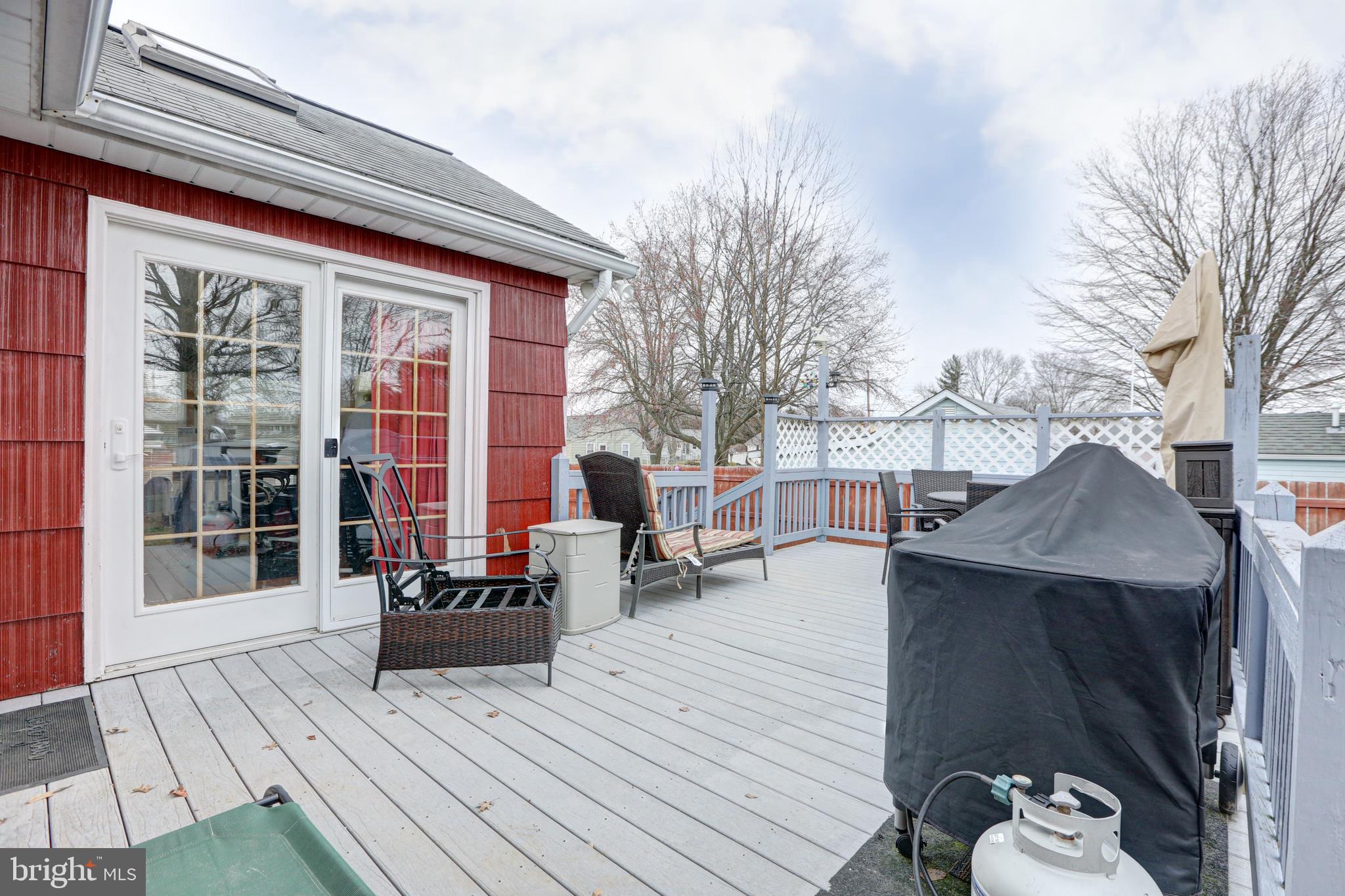 12 Jefferson Road Pennsville, NJ 08070 - Photo 42 of 63 a view of a patio with couches and table and chairs with wooden floor and fence