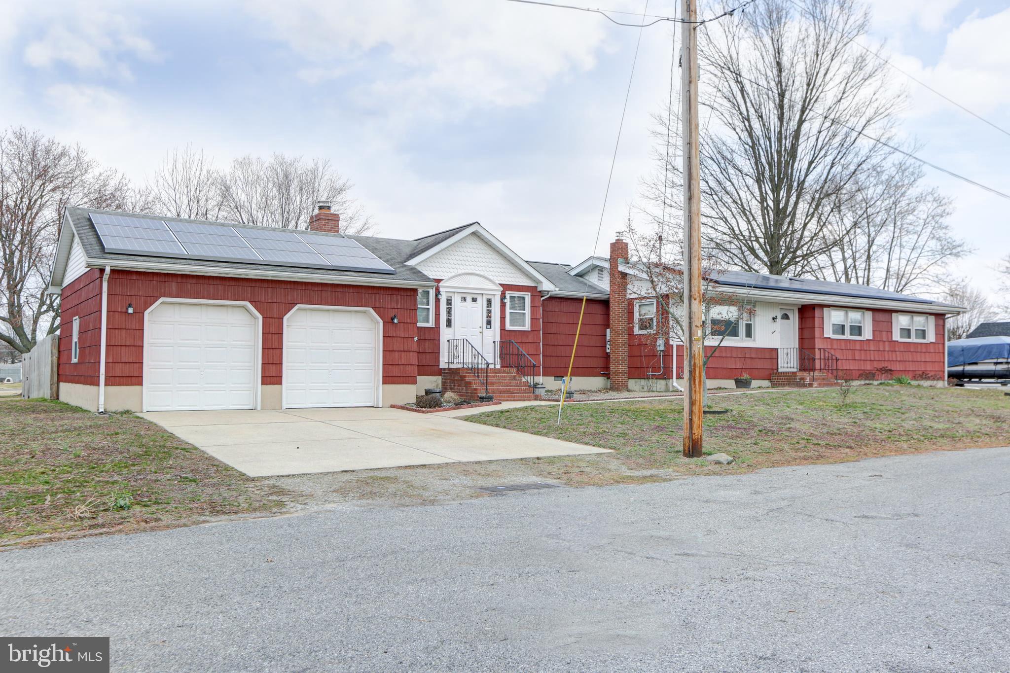 12 Jefferson Road Pennsville, NJ 08070 - Photo 49 of 63 a view of a house with a yard and garage