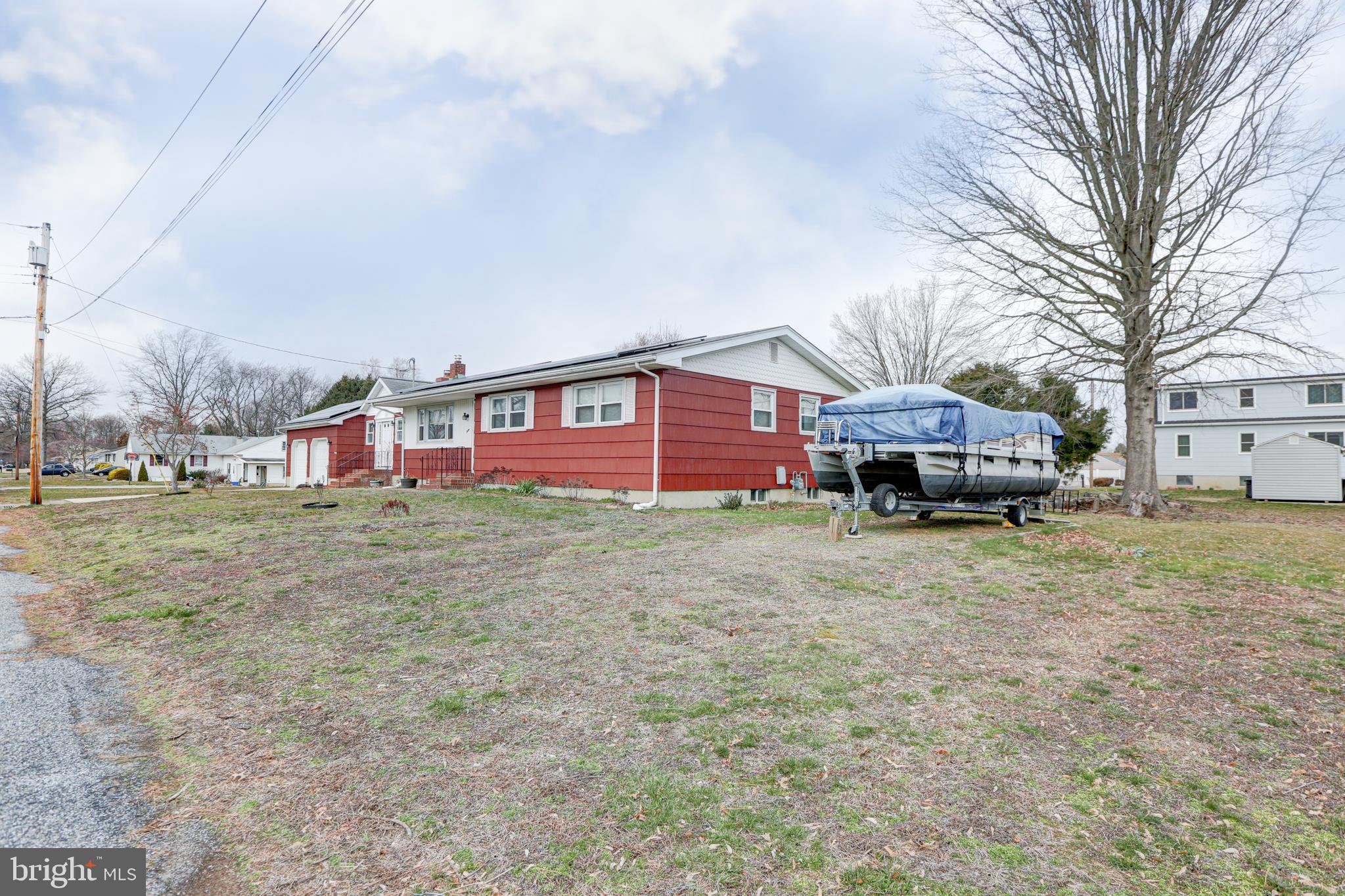 12 Jefferson Road Pennsville, NJ 08070 - Photo 57 of 63 a front view of a house with a garden