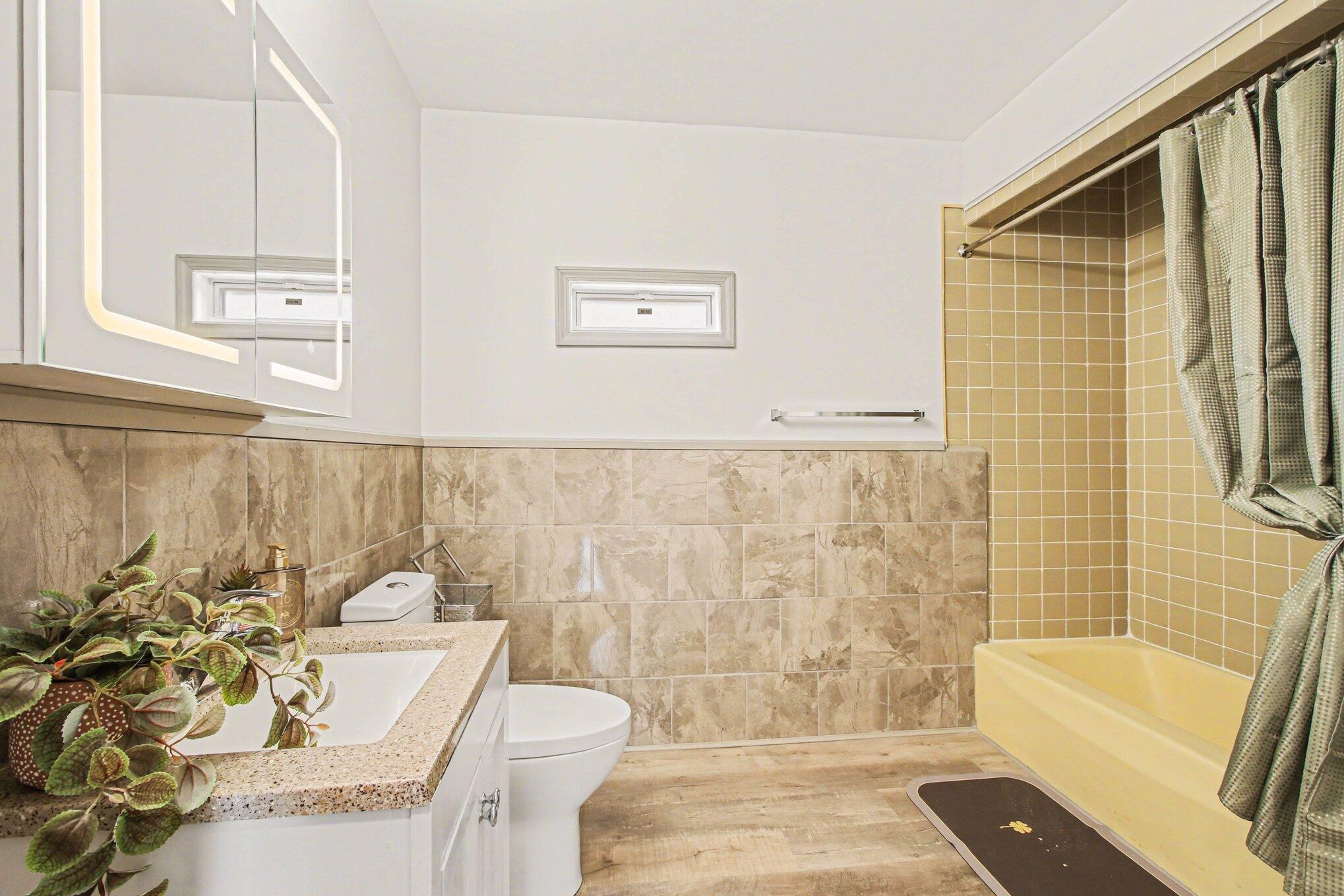 5962 Park Place Hammond, IN 46320 - Photo 19 of 20 a bathroom with a sink a bathtub and a shower