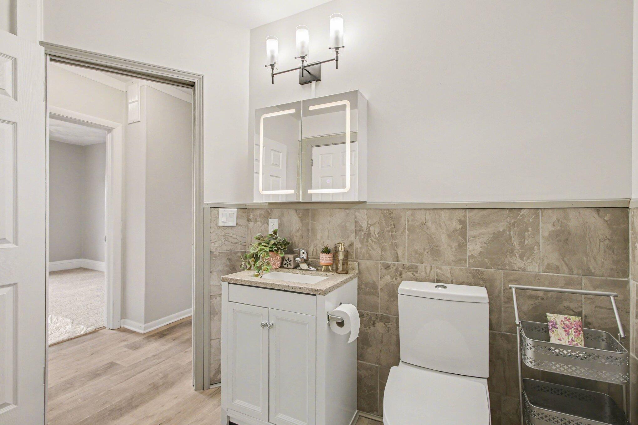 5962 Park Place Hammond, IN 46320 - Photo 8 of 20 a bathroom with a toilet sink and mirror