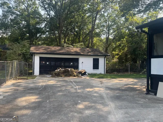 a view of a house with large tree and a yard