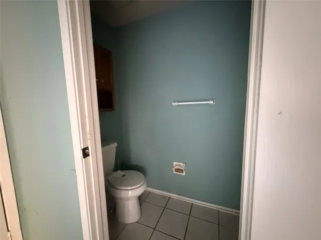 a bathroom with a granite countertop toilet and a sink