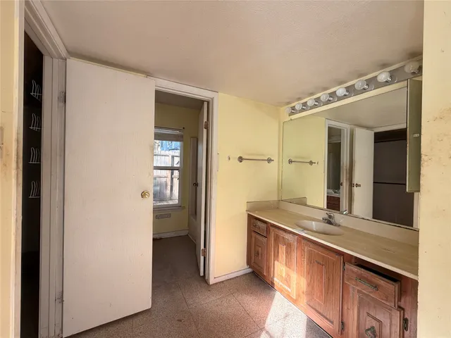 a spacious bathroom with a double vanity sink and a mirror