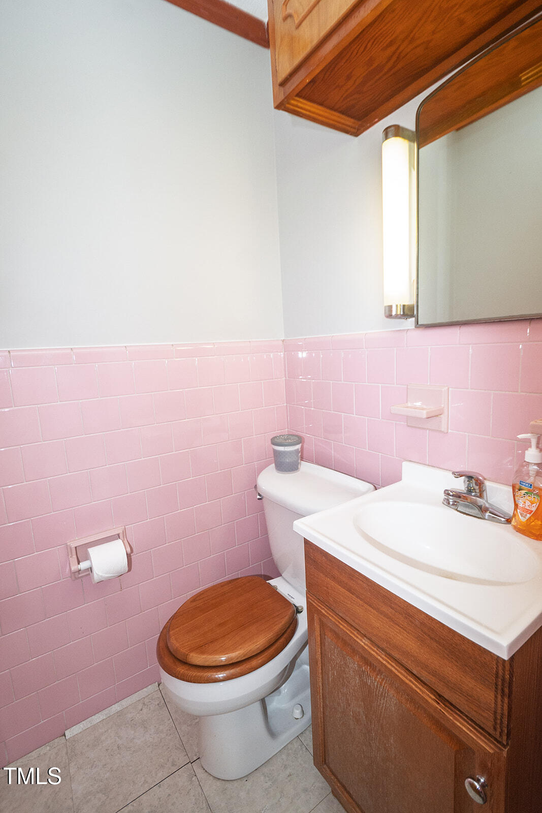 205 North Augusta Avenue Benson, NC 27504 - Photo 15 of 22 a bathroom with a sink a toilet and a mirror