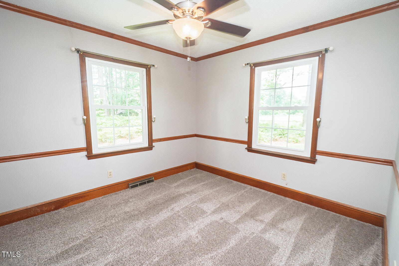 205 North Augusta Avenue Benson, NC 27504 - Photo 17 of 22 an empty room with a window and a fan