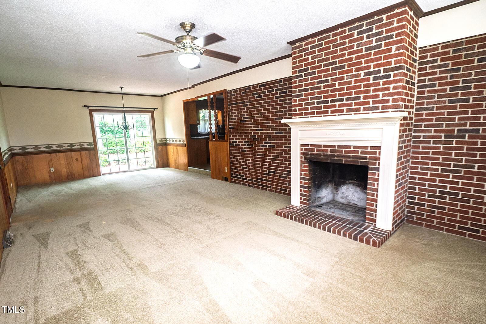 205 North Augusta Avenue Benson, NC 27504 - Photo 6 of 22 a view of an empty room with a fireplace