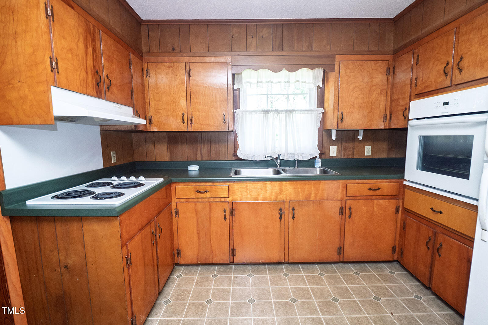 205 North Augusta Avenue Benson, NC 27504 - Photo 9 of 22 a kitchen with stainless steel appliances granite countertop a stove a sink and a microwave