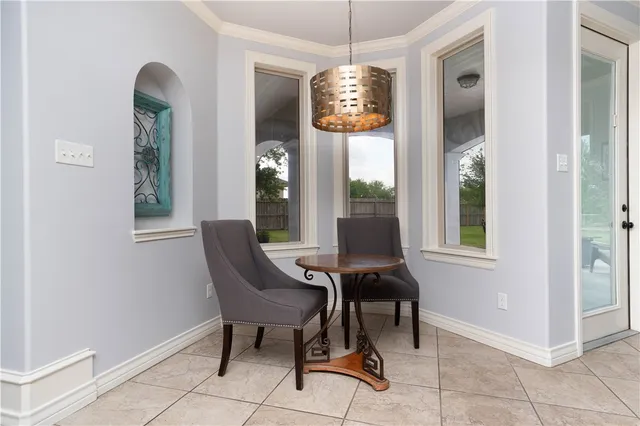 a dining room with furniture and window
