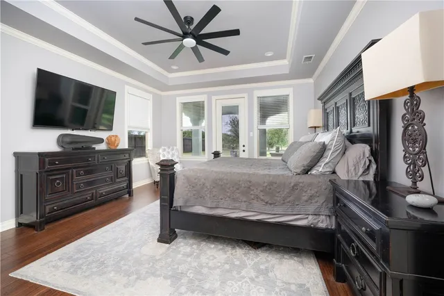 a bedroom with a bed wooden floor and a window