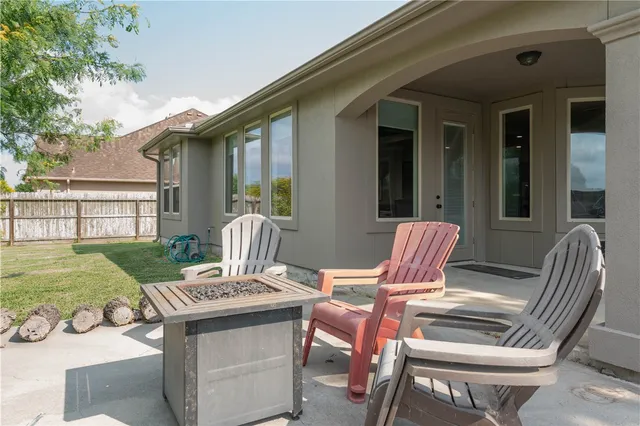 a view of a house with backyard and sitting area