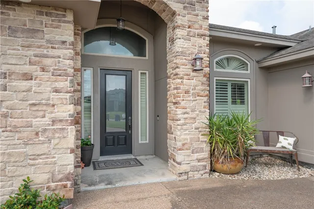 a front view of a house with potted plants
