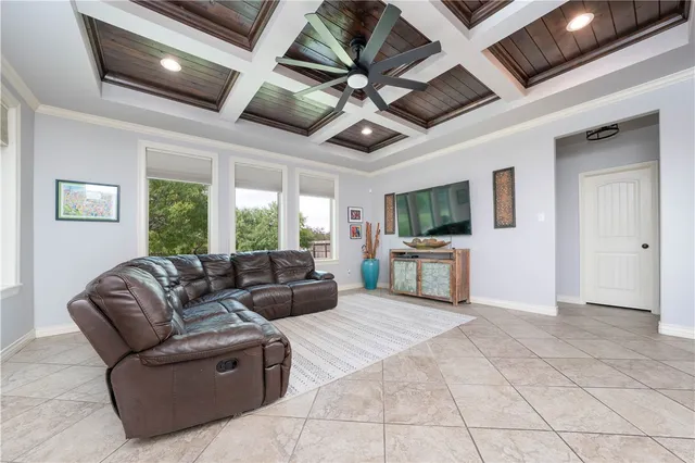 a kitchen with kitchen island granite countertop wooden cabinets and a refrigerator