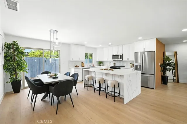 a kitchen with a table and chairs in it