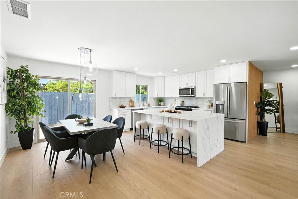 a kitchen with a table and chairs in it