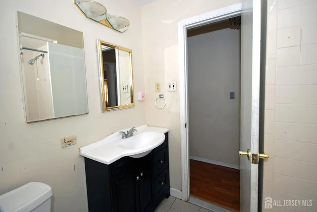 a bathroom with a sink vanity and a mirror