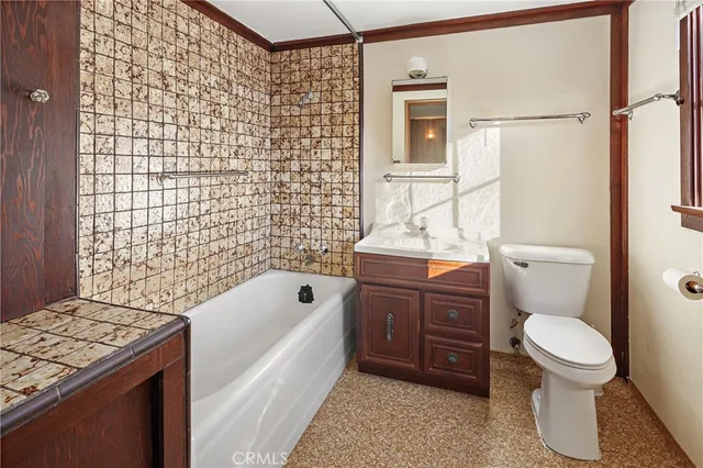 a kitchen with cabinets and wooden floor