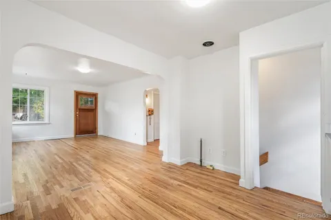 a view of empty room with wooden floor