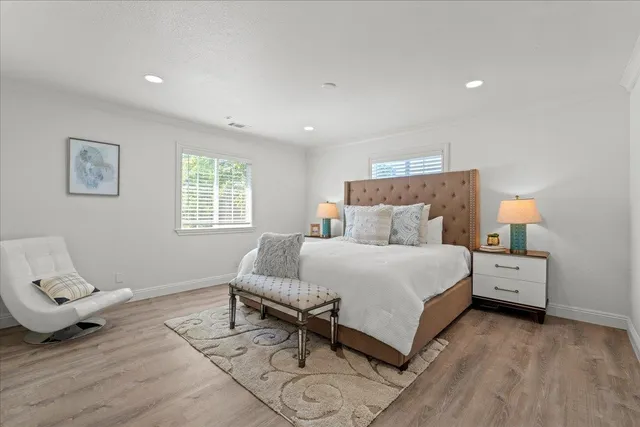 a bed room with a bed and a chair