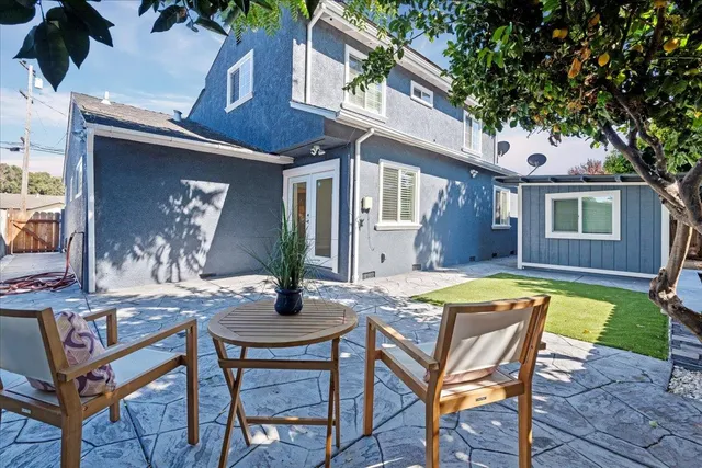 a view of a house with pool and sitting area