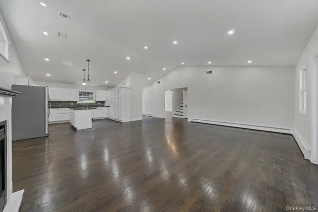 a view of kitchen with refrigerator and window