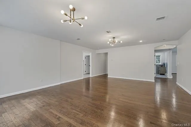 a view of a room with wooden floor and a ceiling fan