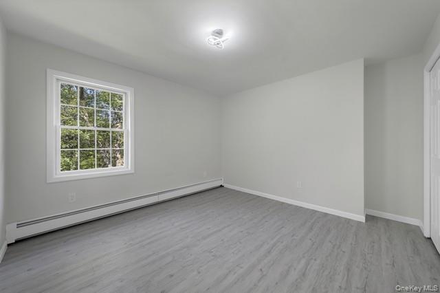 65 Old Cahoonzie Road Sparrowbush, NY 12780 - Photo 30 of 44 an empty room with wooden floor and windows