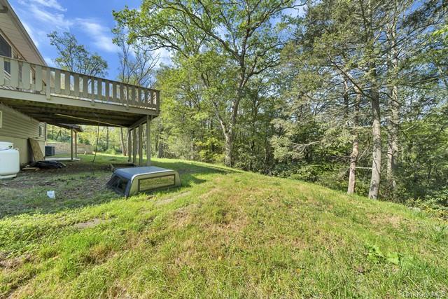 65 Old Cahoonzie Road Sparrowbush, NY 12780 - Photo 42 of 44 a view of a swimming pool with a table and chairs under an umbrella
