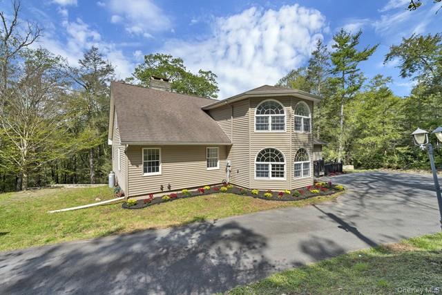 65 Old Cahoonzie Road Sparrowbush, NY 12780 - Photo 6 of 44 a front view of a house with a yard