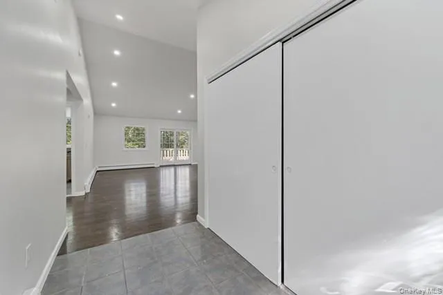 a view of a hallway with wooden floor