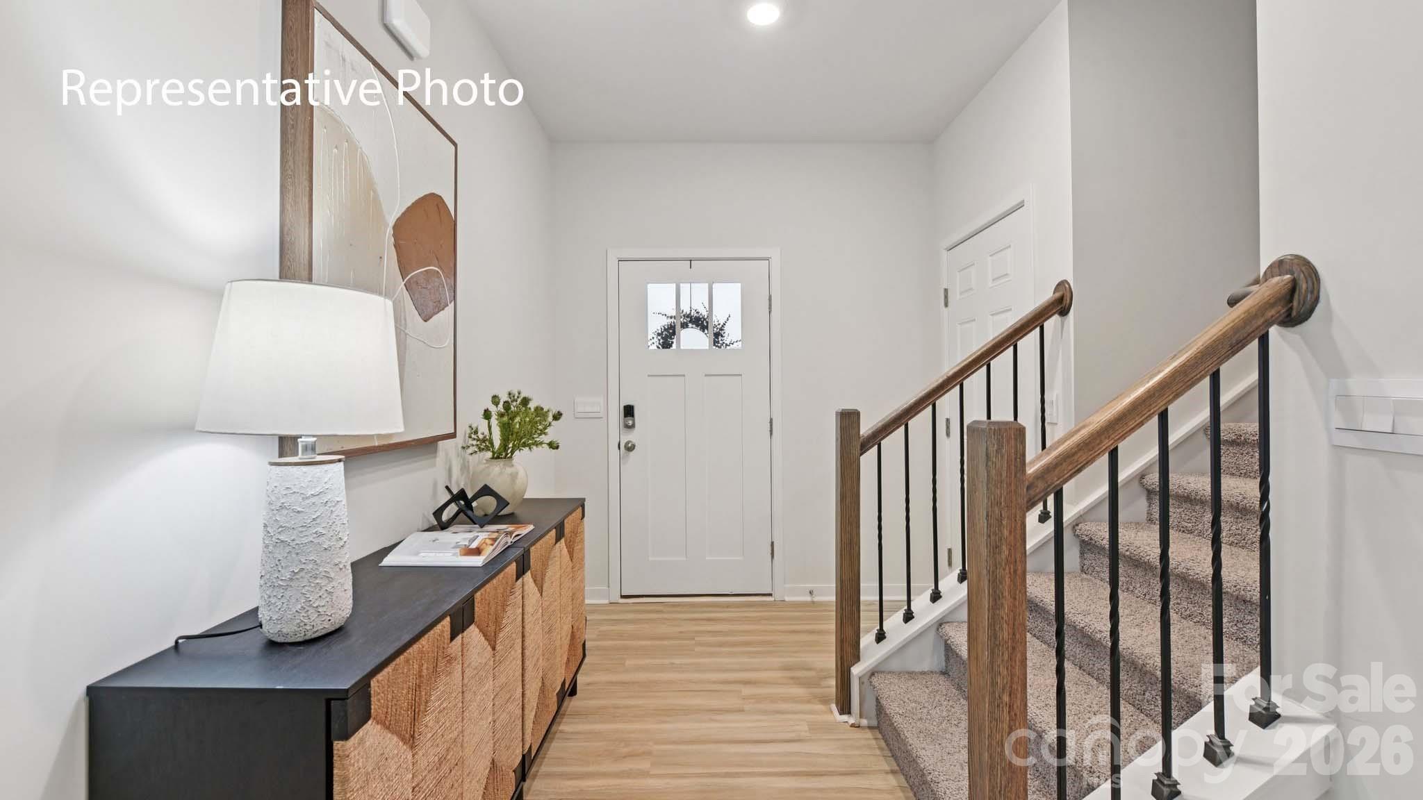 1418 Mammoth Road Hickory, NC 28602 - Photo 2 of 30 a view of a hallway to a livingroom with wooden floor and staircase
