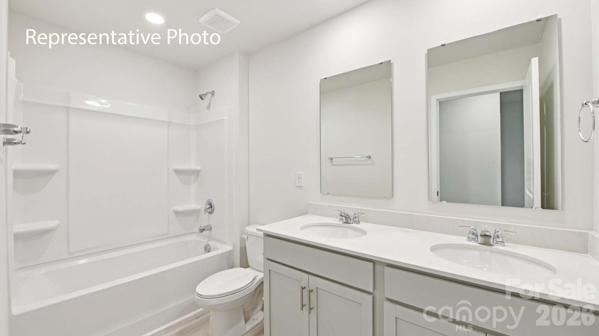 1418 Mammoth Road Hickory, NC 28602 - Photo 21 of 30 a bathroom with a double vanity sink toilet mirror and bathtub