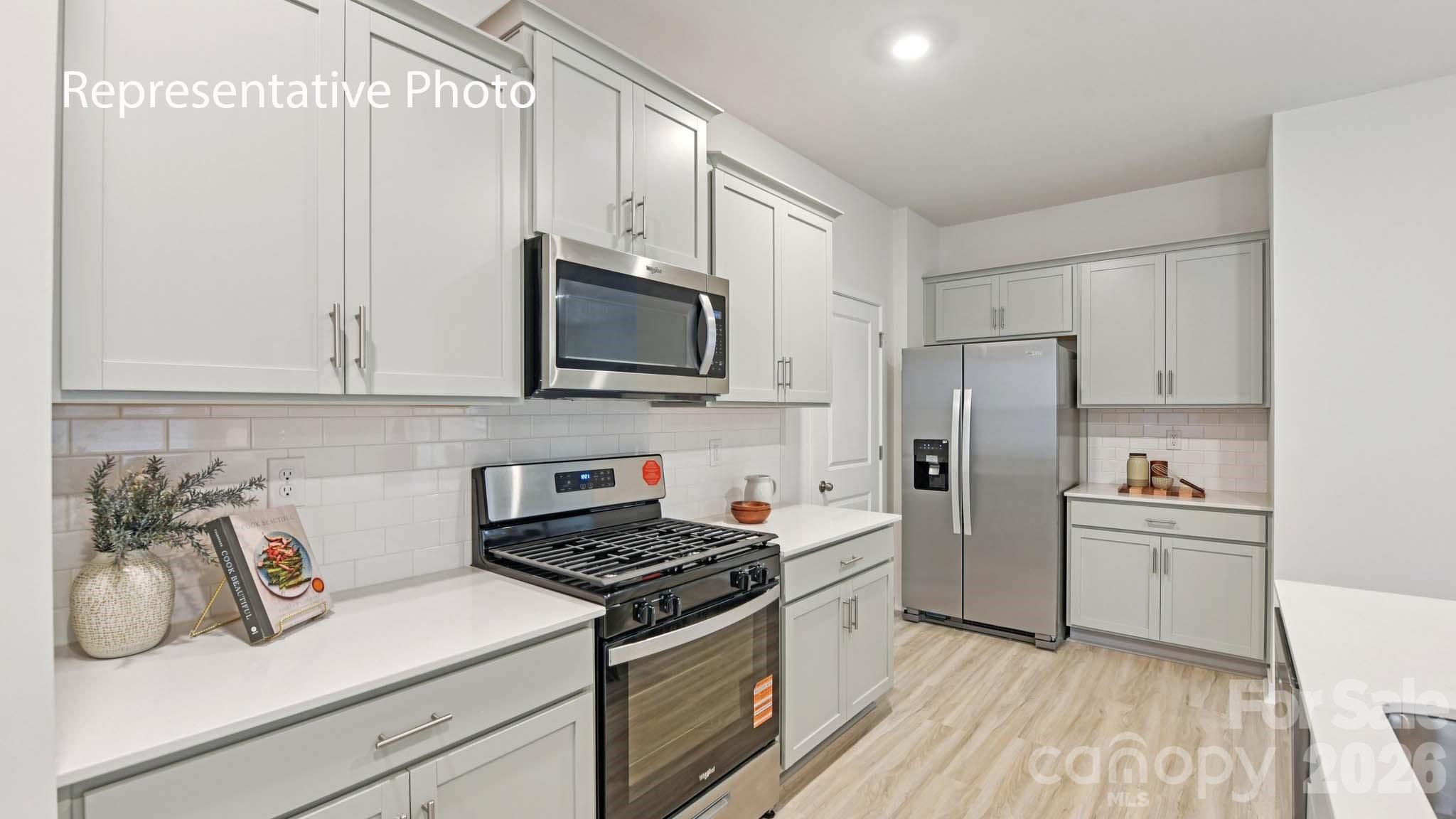 1418 Mammoth Road Hickory, NC 28602 - Photo 9 of 30 a kitchen with cabinets microwave and refrigerator