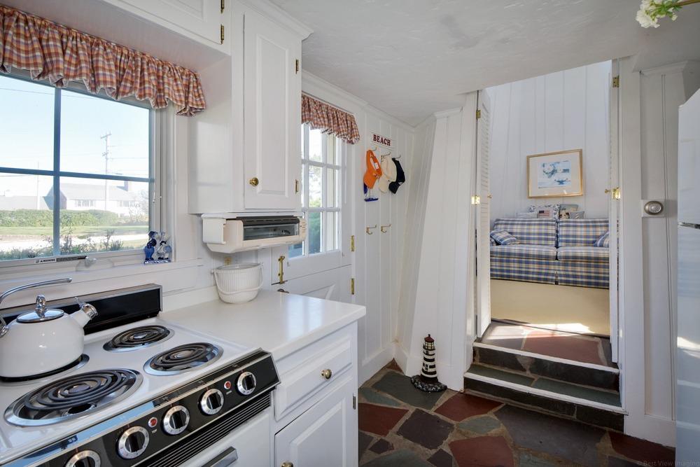 209 Shore Road, Unit 3 Chatham, MA 02633 - Photo 6 of 19 a kitchen that has a stove and a wooden floor