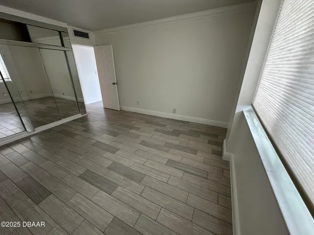 a view of balcony with wooden floor