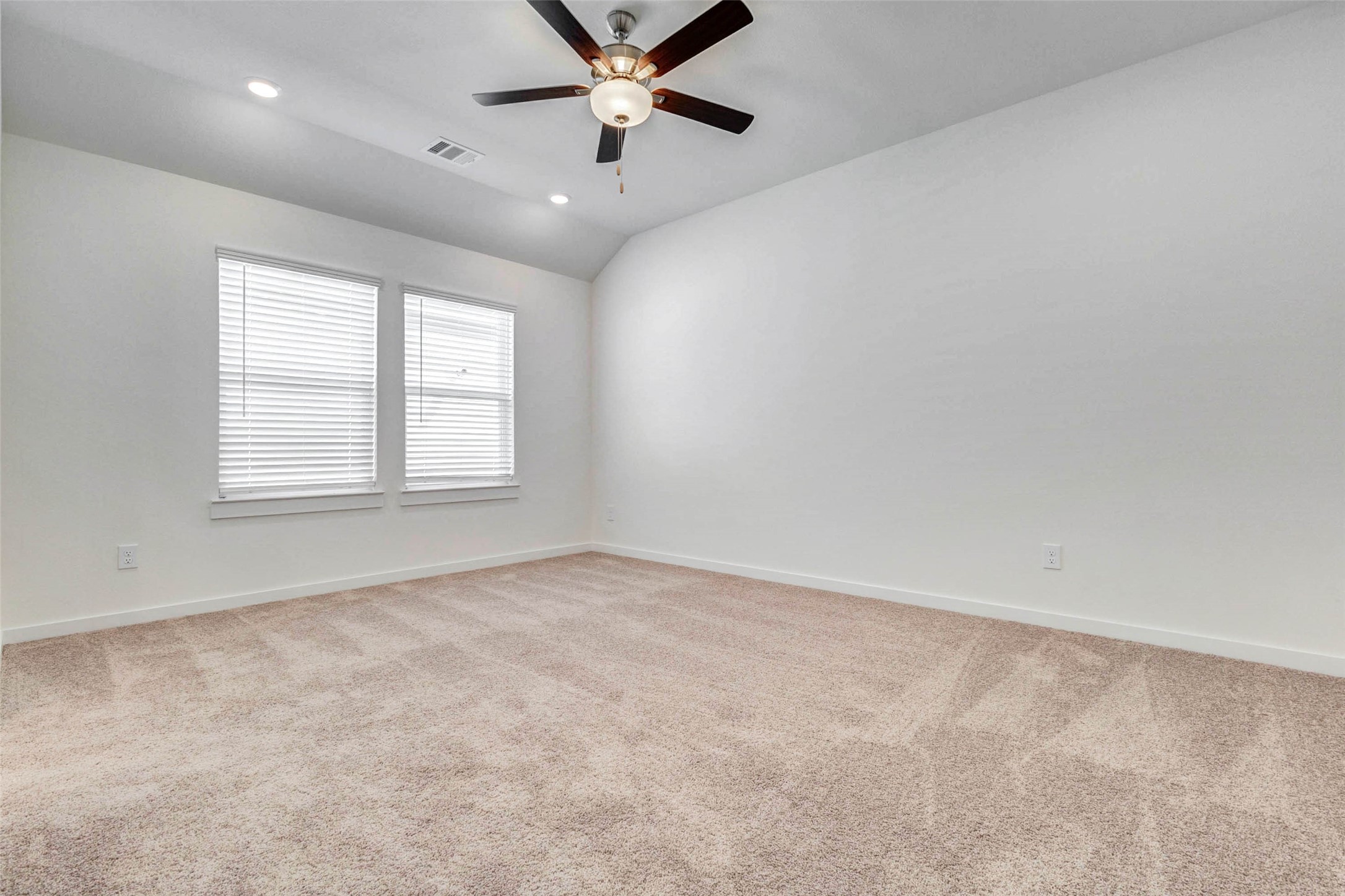 6463 Escondido Drive Rosharon, TX 77583 - Photo 19 of 30 Secondary bedroom with soft carpet, white walls, recessed lighting, and a closet with double doors. The nearby hallway provides easy access to the main living areas and bathroom, creating a practical layout for everyday use.