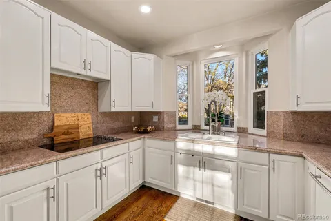 a bathroom with a granite countertop sink a mirror and vanity