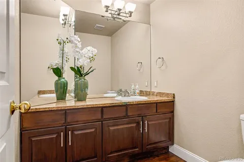 a bathroom with a shower a mirror and a sink