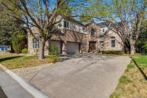 a view of a brick house with a small yard and wooden floor and fence