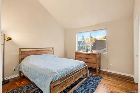 a view of a room with wooden floor and furniture