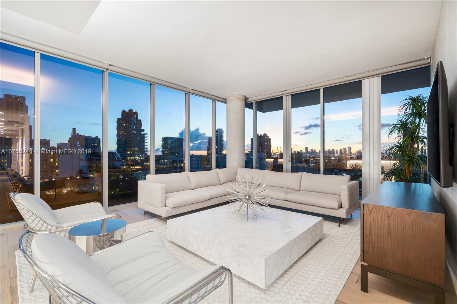 321 Ocean Drive, Unit PH Miami Beach, FL 33139 - Photo 18 of 43 a living room with couches a coffee table and a large window with garden view