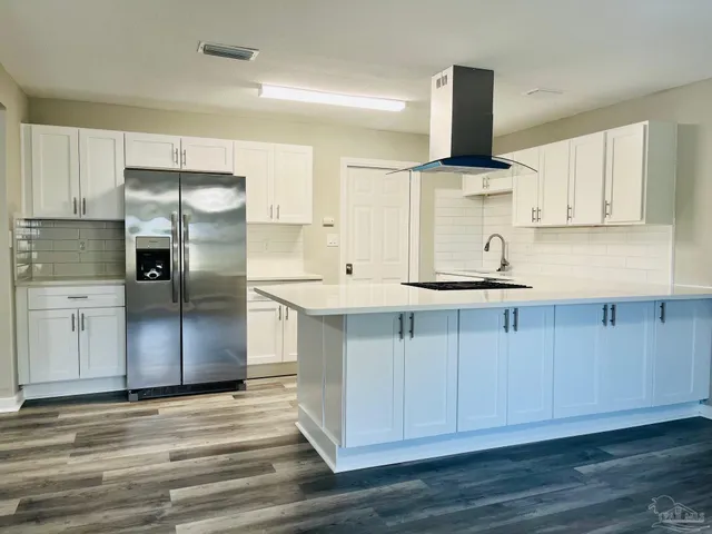 a kitchen with stainless steel appliances a stove a sink and a refrigerator