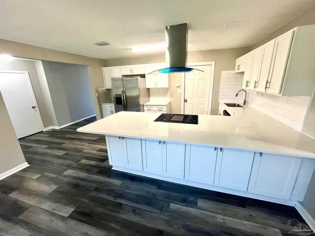 a white stove top oven sitting inside of a kitchen