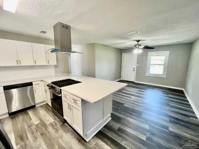 a kitchen with a stove and a refrigerator