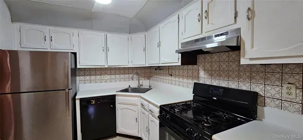 a kitchen with a refrigerator and a stove